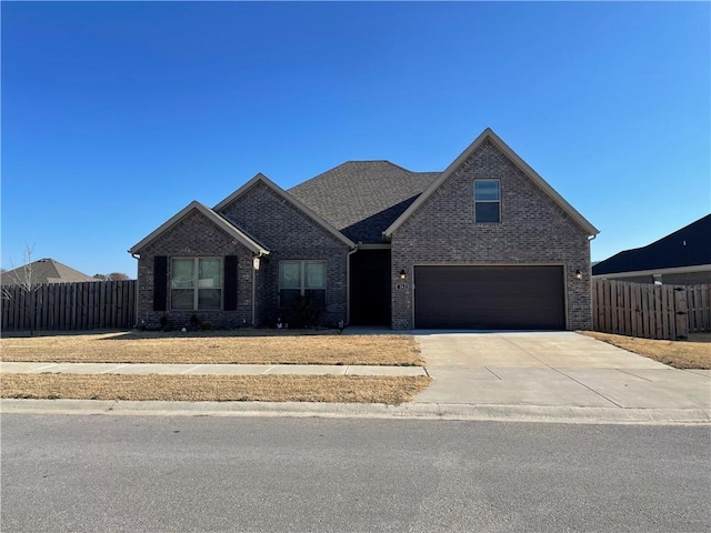 view of front of house featuring concrete driveway and brick siding