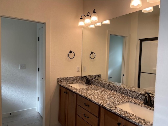 bathroom featuring tile patterned flooring and vanity