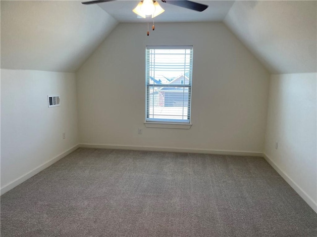 bonus room featuring lofted ceiling, visible vents, a ceiling fan, carpet flooring, and baseboards