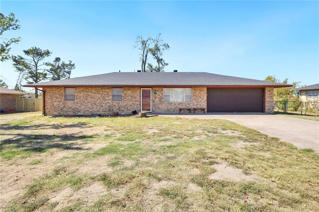 single story home with a garage and a front lawn