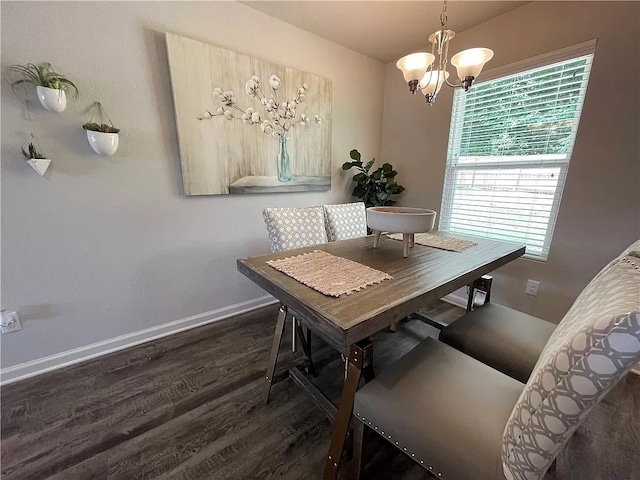 dining area with dark hardwood / wood-style floors and a notable chandelier