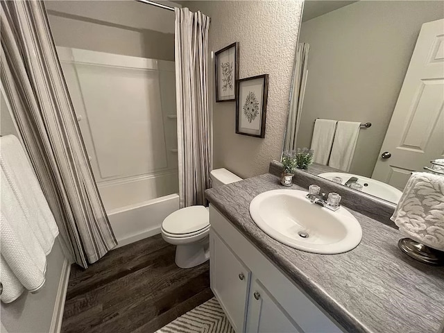 full bathroom with shower / bath combo, toilet, wood-type flooring, and vanity