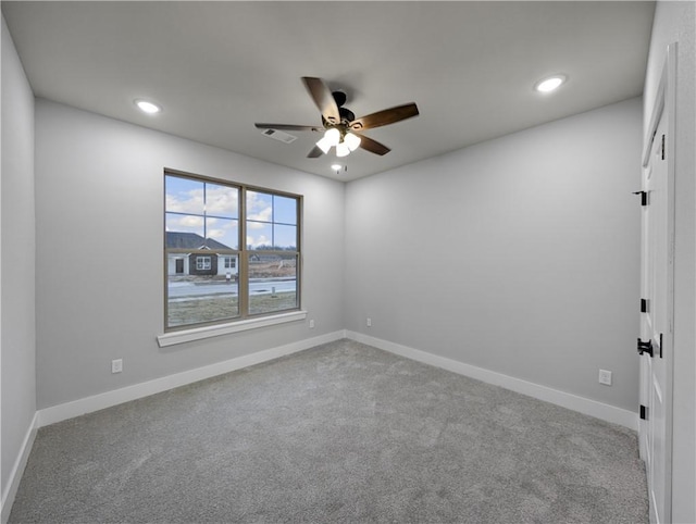 carpeted spare room with ceiling fan