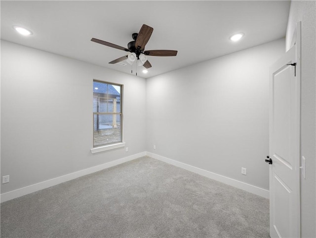 spare room with ceiling fan and carpet flooring