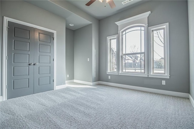 unfurnished bedroom featuring ceiling fan, carpet floors, and a closet