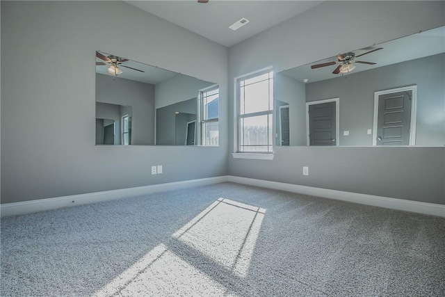 empty room with ceiling fan and carpet floors