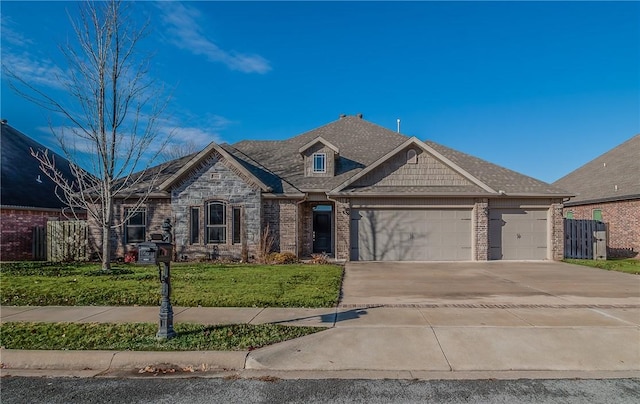 view of front of property featuring a front yard and a garage