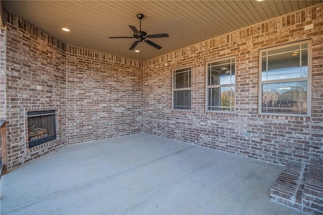 view of patio / terrace featuring an outdoor brick fireplace and ceiling fan