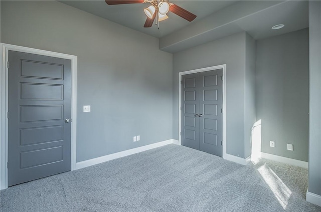 unfurnished bedroom featuring carpet and ceiling fan