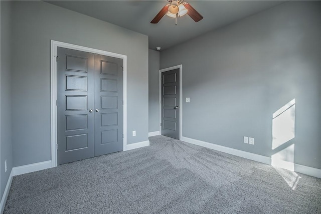 unfurnished bedroom with ceiling fan, carpet floors, and a closet