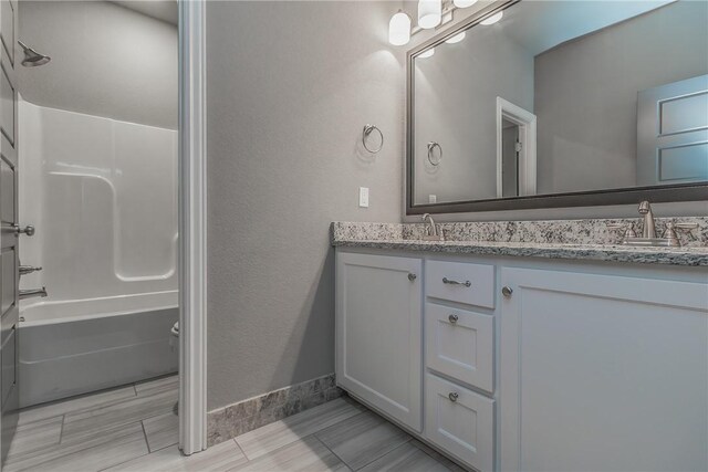 bathroom featuring vanity and shower / washtub combination