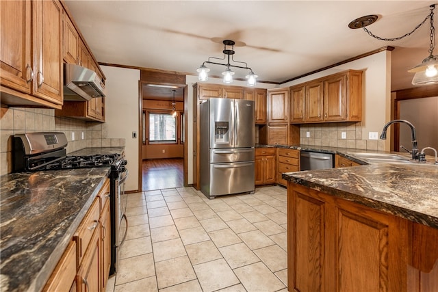 kitchen featuring decorative light fixtures, sink, backsplash, and appliances with stainless steel finishes