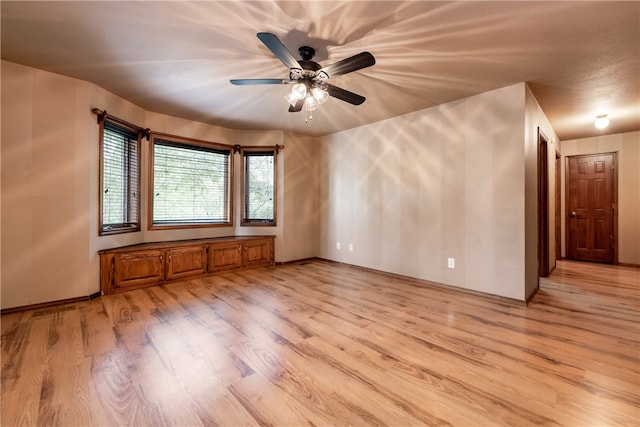 spare room with ceiling fan and light hardwood / wood-style floors