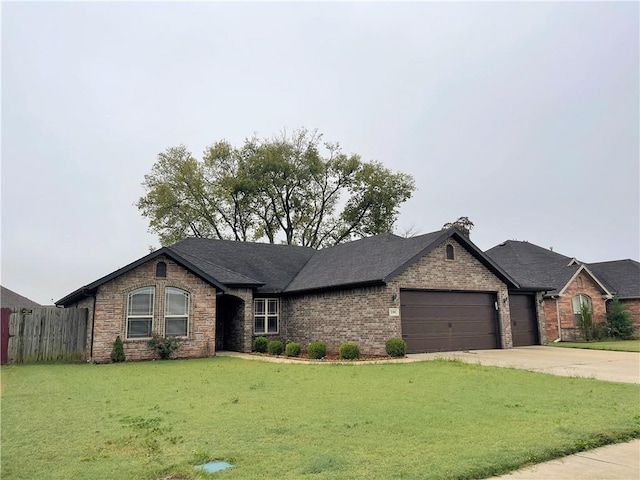 view of front of property with a front yard and a garage