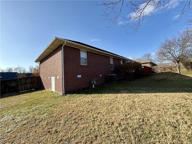 view of property exterior with a yard and central AC