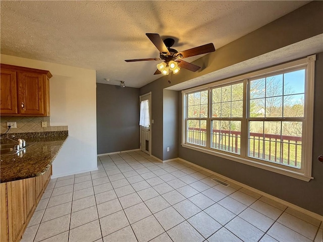 interior space featuring ceiling fan and a textured ceiling