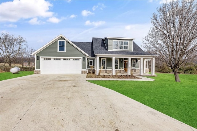 view of front facade featuring a porch, a shingled roof, concrete driveway, an attached garage, and a front yard