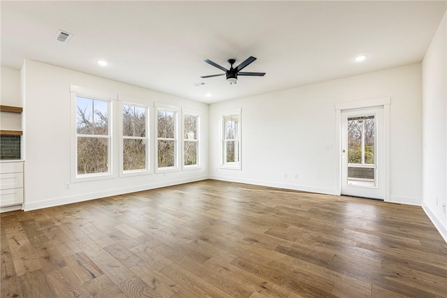 unfurnished living room with ceiling fan, visible vents, wood finished floors, and recessed lighting