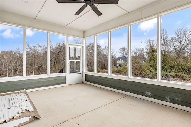 unfurnished sunroom featuring ceiling fan