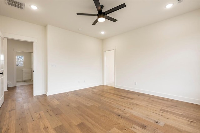 spare room featuring light wood finished floors, baseboards, visible vents, a ceiling fan, and recessed lighting