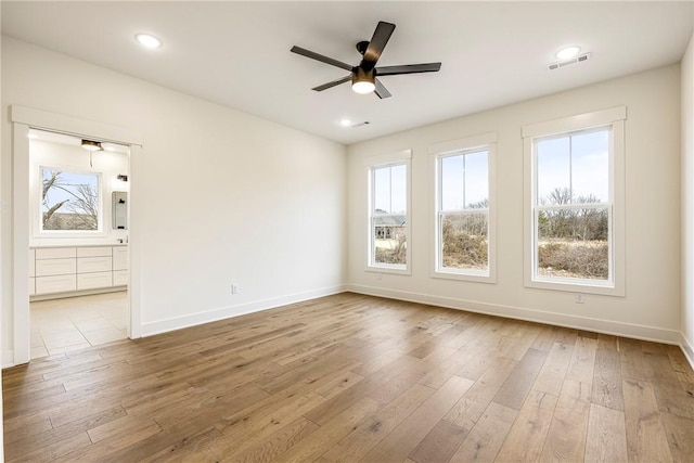 interior space featuring visible vents, baseboards, and wood finished floors