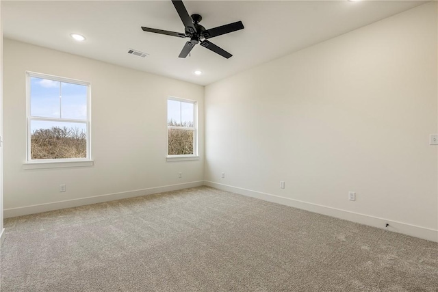 spare room with carpet floors, baseboards, and recessed lighting