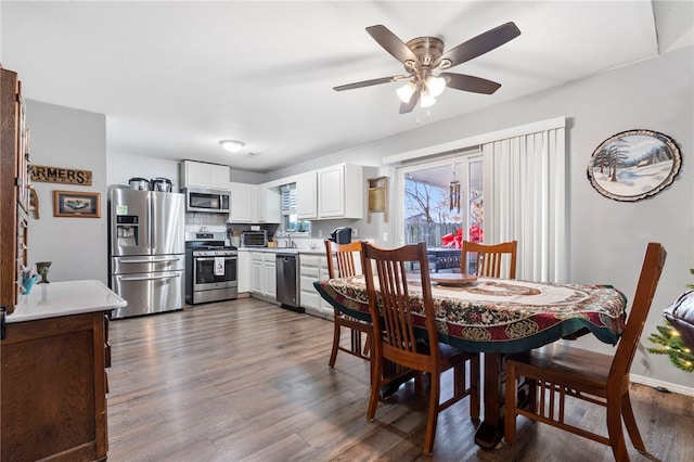 dining room featuring dark hardwood / wood-style floors and ceiling fan