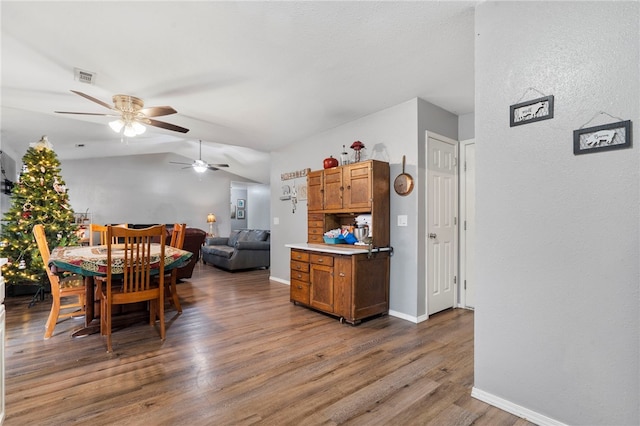 dining room featuring hardwood / wood-style flooring and lofted ceiling