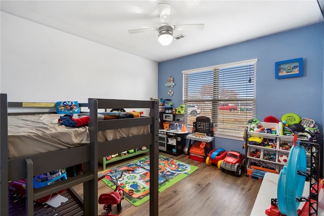 bedroom with ceiling fan and hardwood / wood-style floors