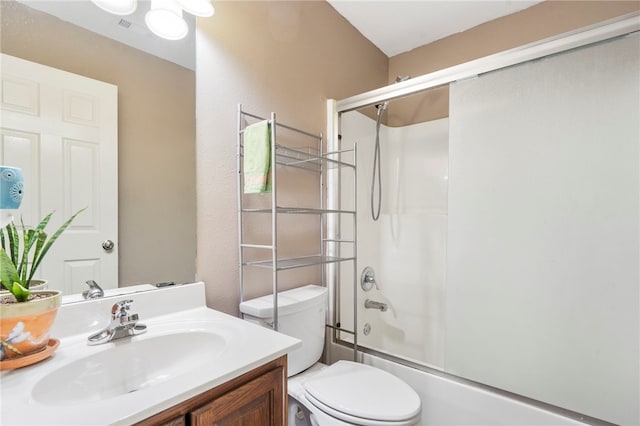 full bathroom featuring vanity, combined bath / shower with glass door, and toilet