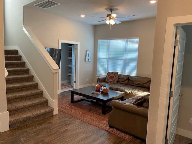 living room featuring dark hardwood / wood-style floors and ceiling fan