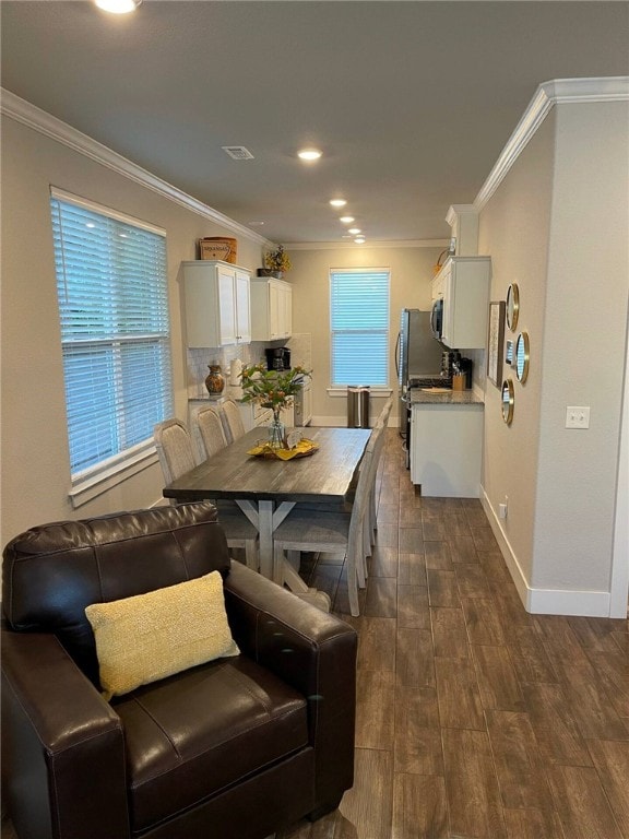 dining space featuring ornamental molding and dark hardwood / wood-style floors