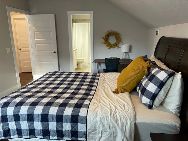 bedroom with lofted ceiling and ensuite bathroom