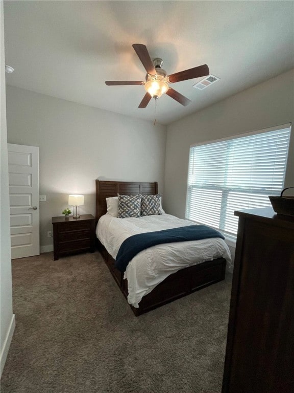 bedroom featuring dark carpet and ceiling fan