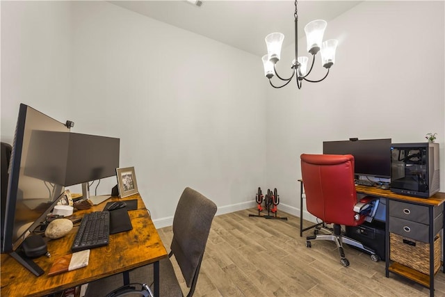 office space with light hardwood / wood-style flooring and an inviting chandelier