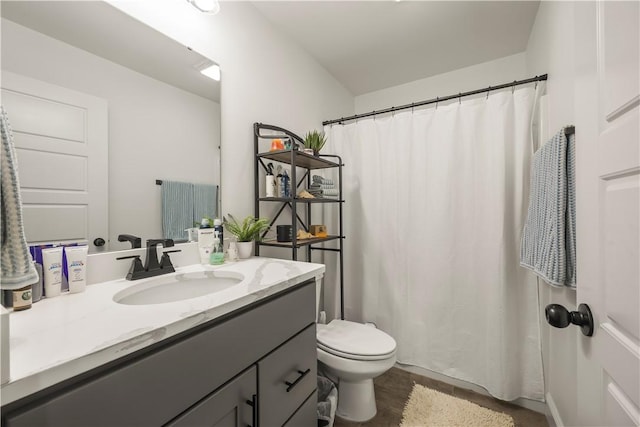 bathroom featuring hardwood / wood-style floors, vanity, and toilet