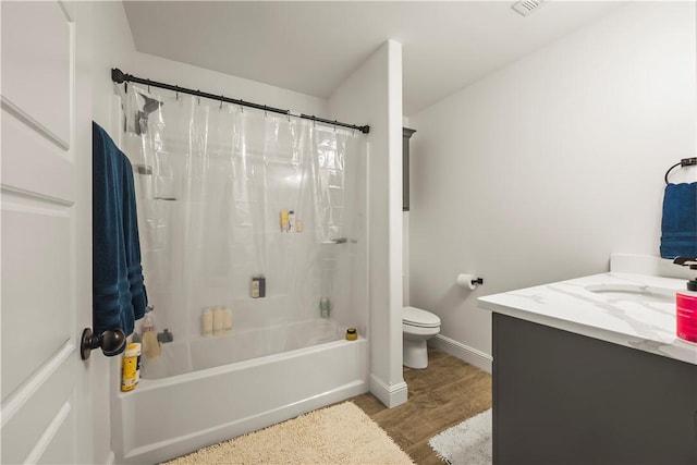 full bathroom with hardwood / wood-style floors, vanity, toilet, and shower / bath combo with shower curtain