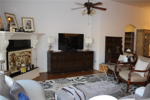 living room with ceiling fan and dark wood-type flooring