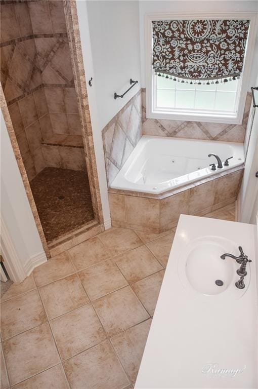 bathroom with tile patterned flooring, separate shower and tub, and sink