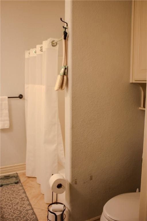 bathroom featuring tile patterned flooring and toilet