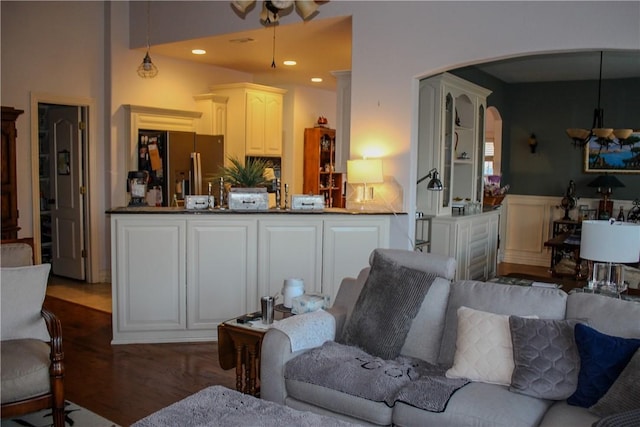 living room with ceiling fan and dark hardwood / wood-style flooring