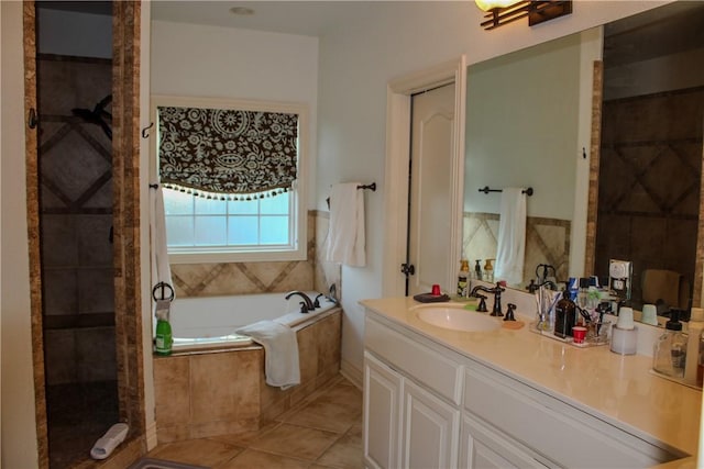 bathroom featuring tile patterned flooring, vanity, and separate shower and tub