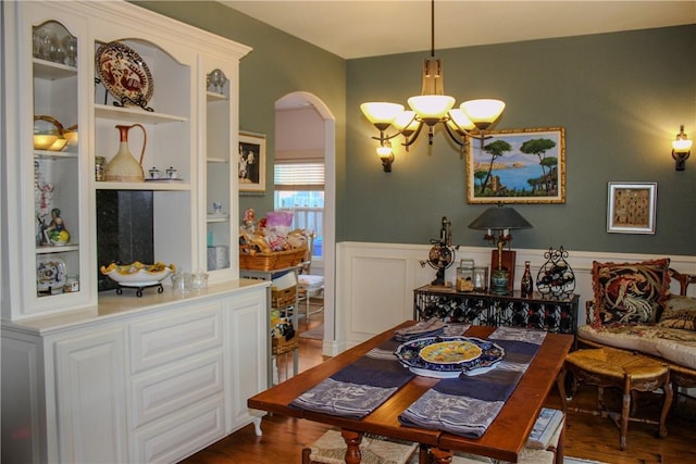 dining space featuring a notable chandelier and dark hardwood / wood-style floors