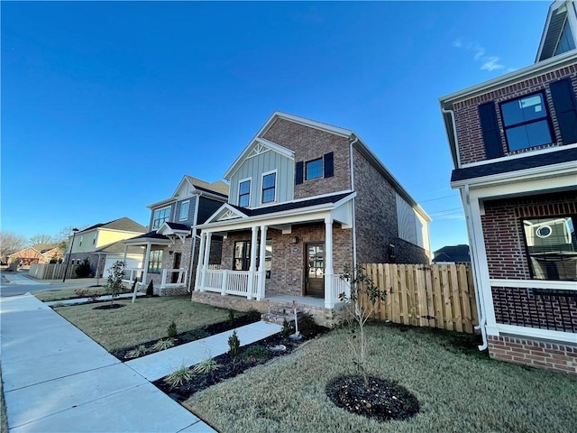 view of front of house with covered porch and a front yard