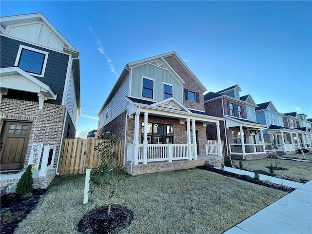 view of front of house featuring covered porch and a front yard