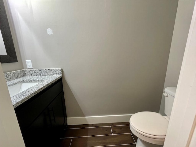 bathroom featuring tile patterned floors, vanity, and toilet