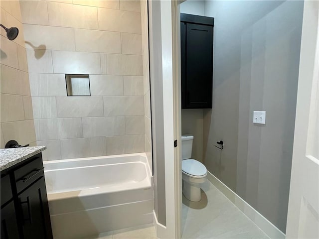 full bathroom with tile patterned floors, vanity, tiled shower / bath combo, and toilet