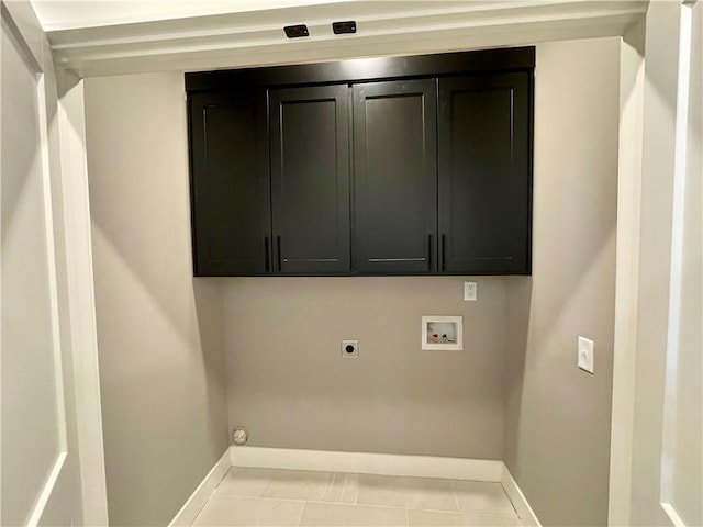 washroom with hookup for an electric dryer, light tile patterned flooring, cabinets, and hookup for a washing machine