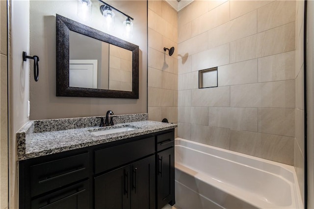 bathroom featuring vanity and tiled shower / bath