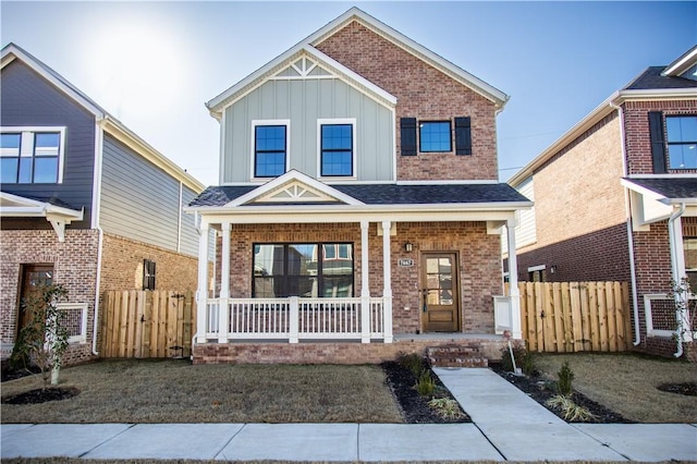 view of front of home with covered porch and a front lawn